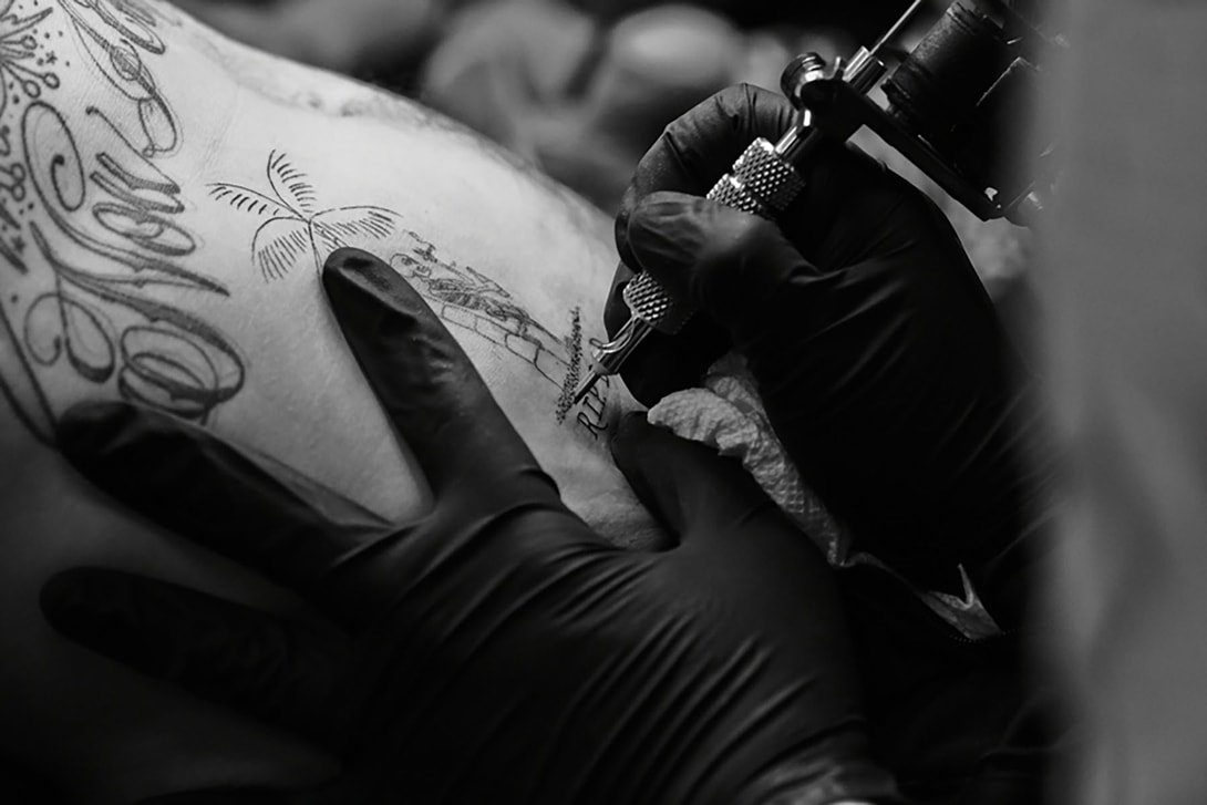 Dr Woo (Brian Woo) while tattooing, photographed by Andrew Arthur, via Hyperbeast