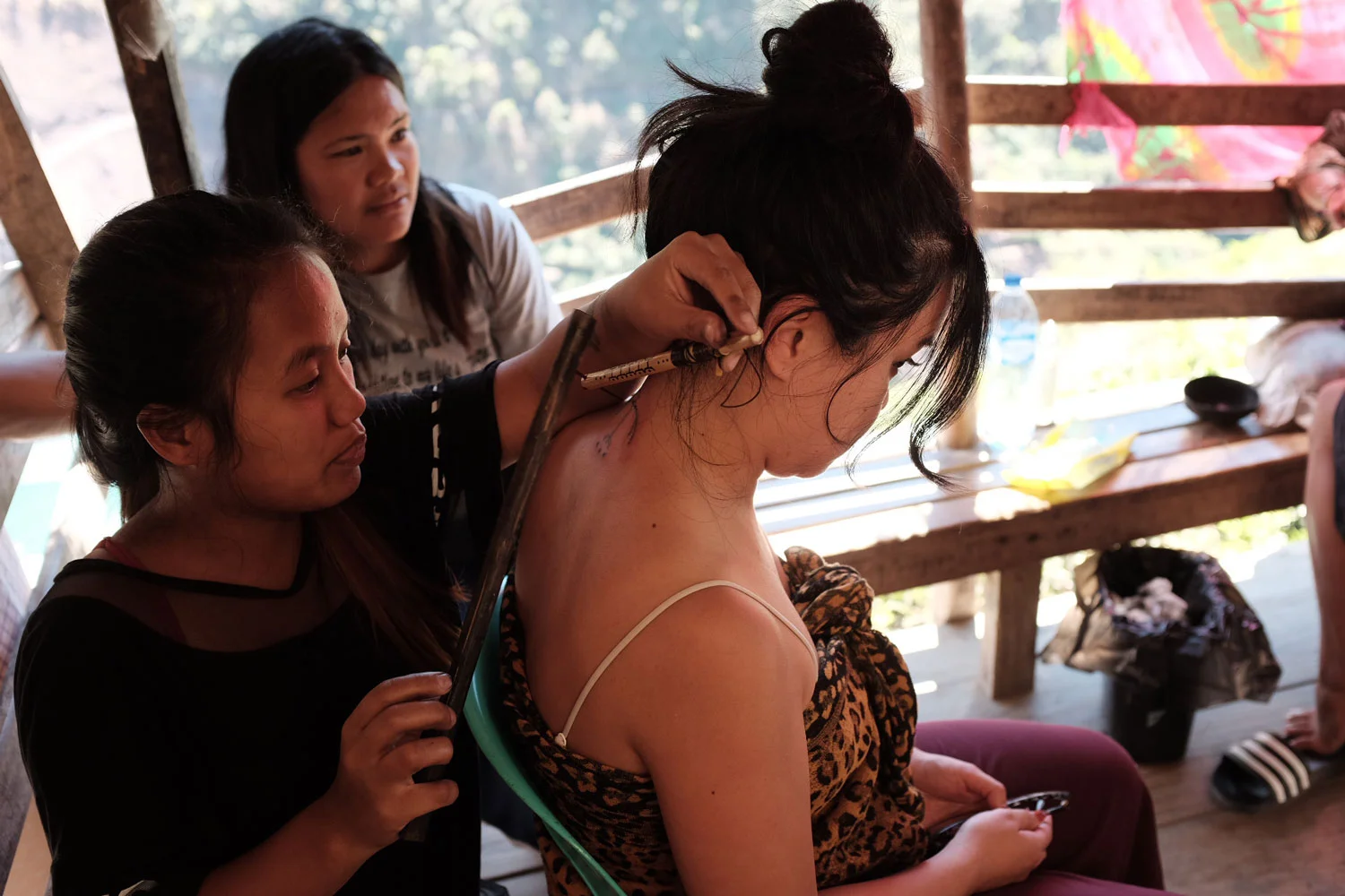 Elyang while tattooing an eagle on Maia Almendral Esteves, photo by Jensen Esteves, via Positively Filipino (www.positivelyfilipino.com)
