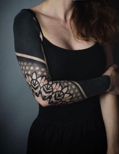 Blackout, blackwork and geometry tattoo (artist unknown) via Pinterest