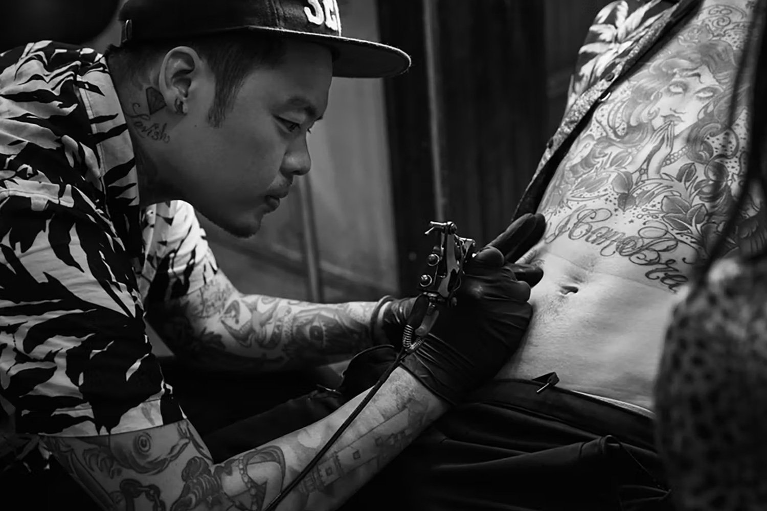 Dr. Woo (Brian Woo) while tattooing, photographed by Andrew Arthur, via Hyperbeast