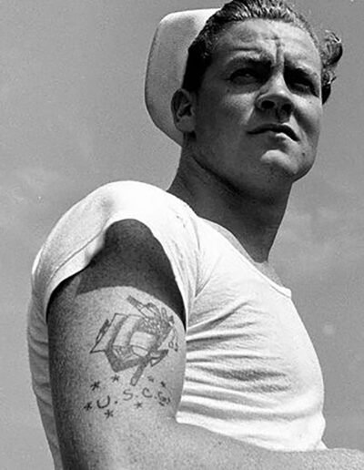 An anchor tattoo on the arm of a marine boy (original source unknown)