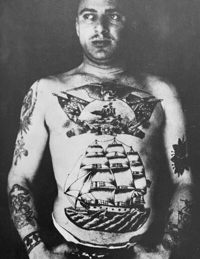Anonymous photograph of a man with a ship tattoo from Heavily Tattooed Men And Women by Spider Webb, McGraw Hill, 1976