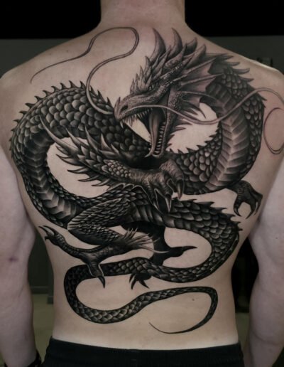 Black-and-grey fantasy dragon back tattoo by Anderson Tavares da Silva @negoart
