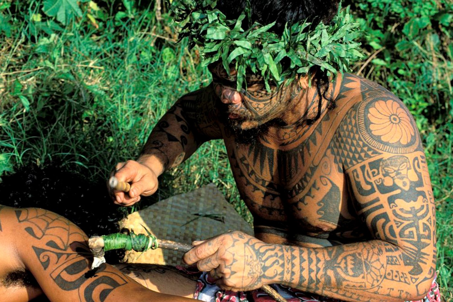 Marquesan tattoo in making, photo by Sylvain Grandadam, via Univers Voyage (universvoyage.com)