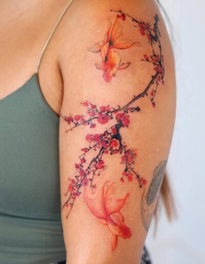 Plum blossom and goldfish tattoo by Eunyu @eunyutattoo