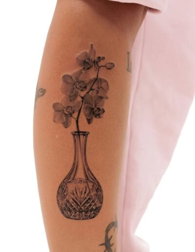 Decanter with orchids by SAV @savv.ink